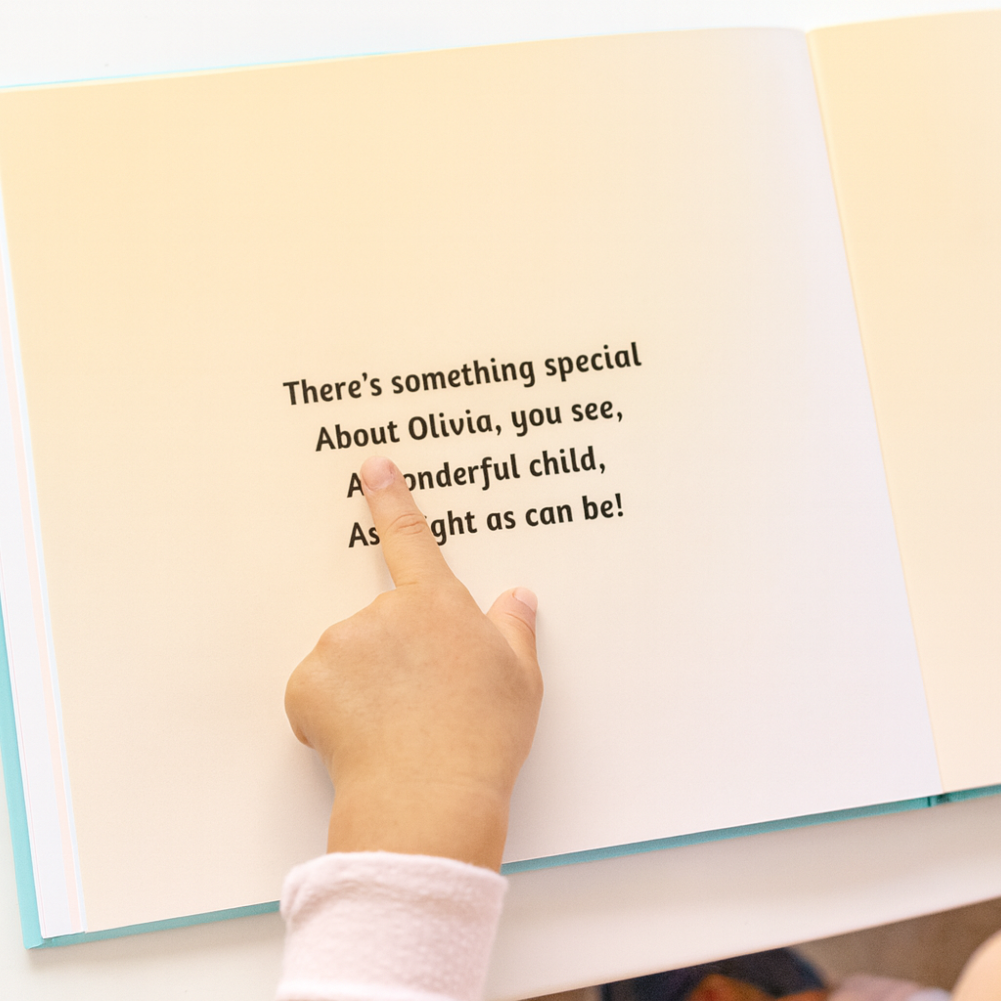 Hand pointing to a personalized message in a book