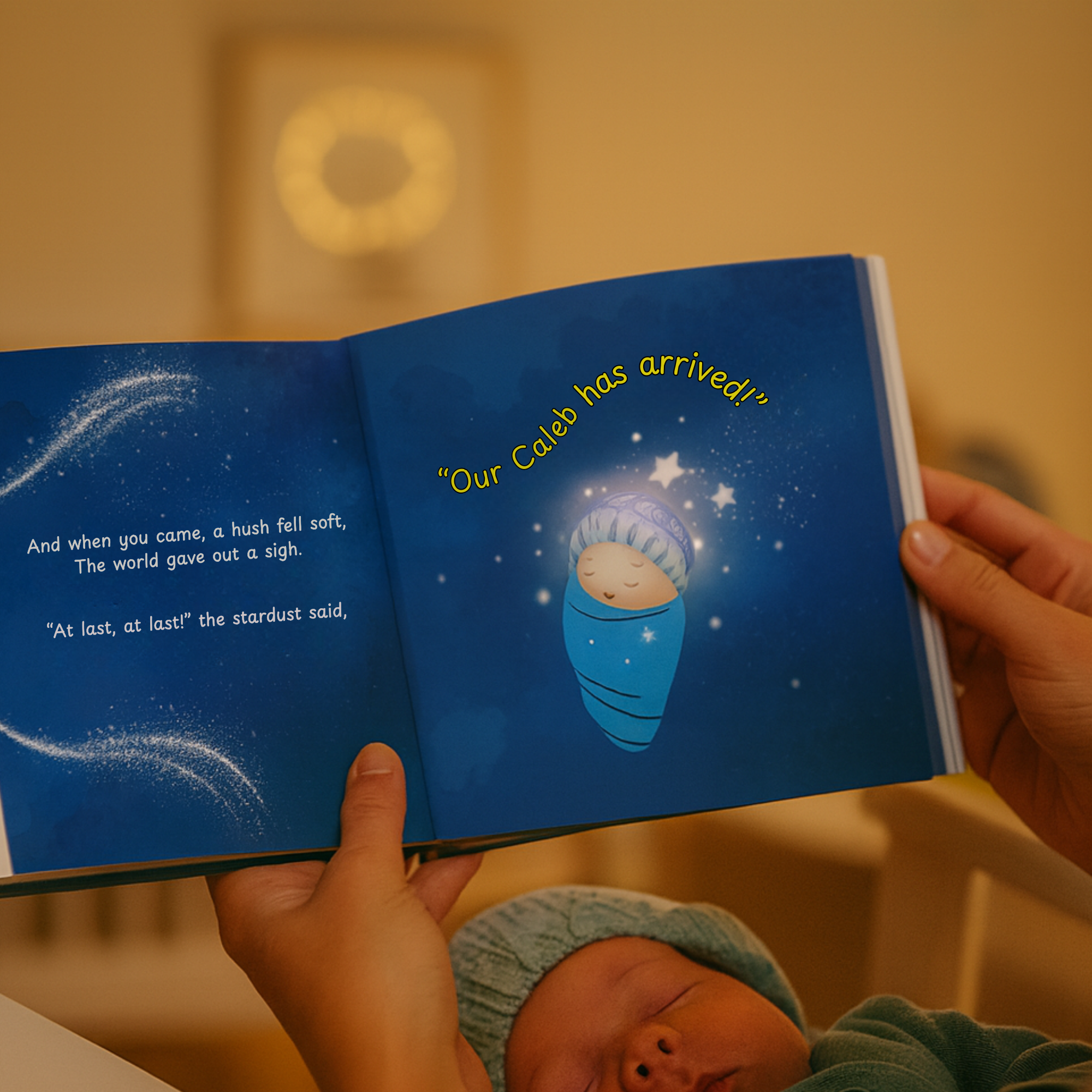 Person holding a book with a baby illustration and text, with a baby lying on a surface below.