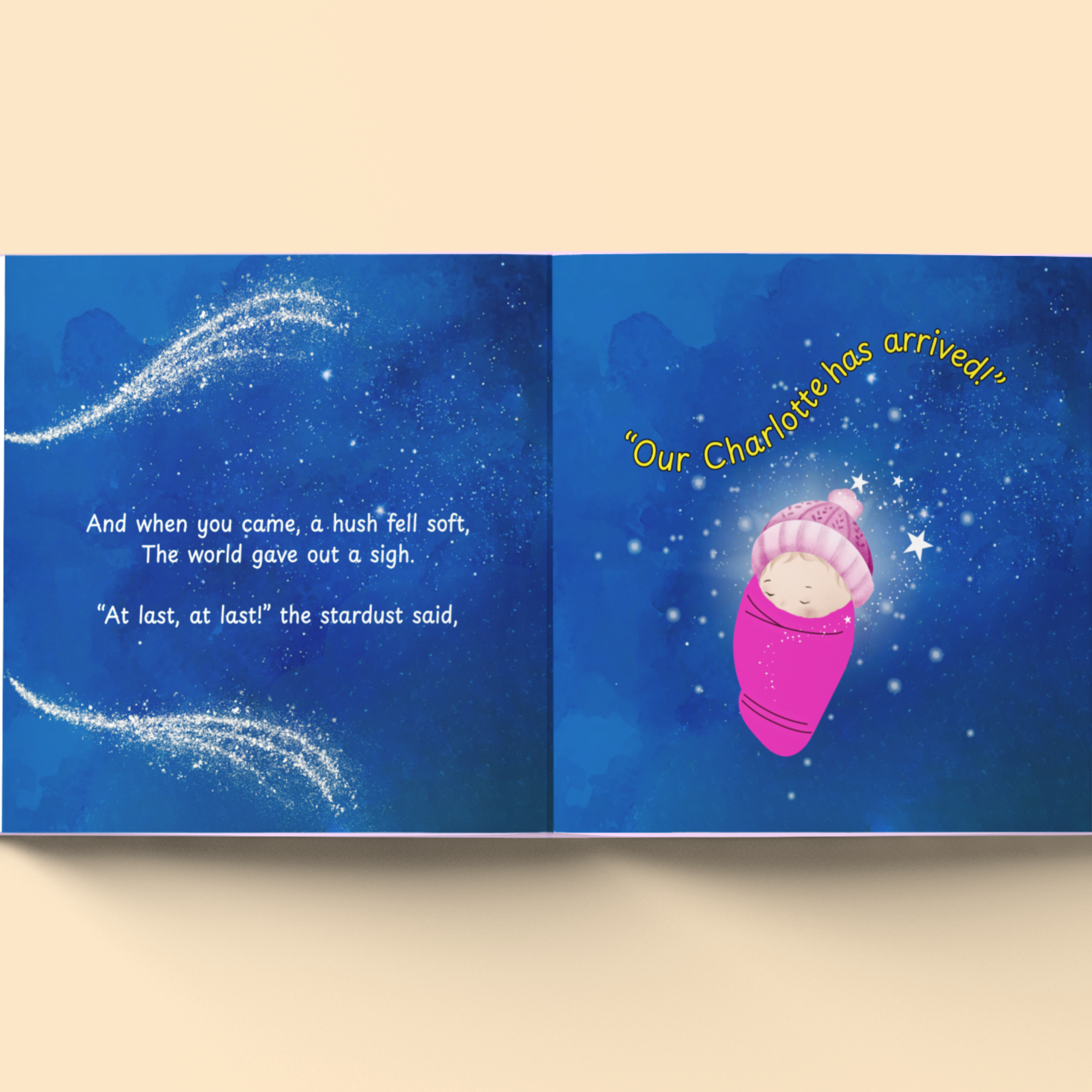 Book open to a page with a baby in a pink blanket and text on a blue background
