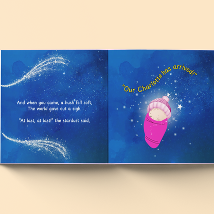 Book open to a page with a baby in a pink blanket and text on a blue background